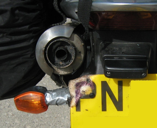 the rear of iw's bike showing the melted numberplate and indicator taped on